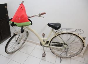 a bike with a watermelon hat on the back at The Secret Place in Melaka