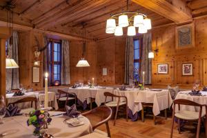 a dining room with white tables and chairs at Grand Hotel Kronenhof in Pontresina