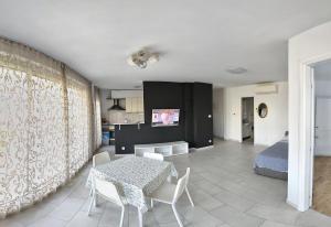 a living room with a table and a bed at Apartments Mariot in Split