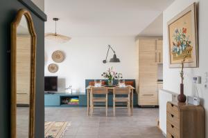 a kitchen and dining room with a table and chairs at Les Sternes - Appt proche de la plage in Saint Malo +4 photos
