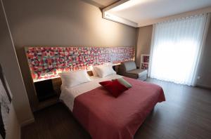 a bedroom with a large bed with a red blanket at Bed In Centro in Naples