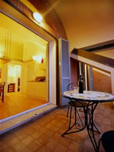 a room with a table and a view of a living room at Sinfonia Bellini - Central 2-Room-Flat in Verbania