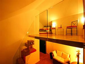 a living room with a couch and a bedroom at Sinfonia Bellini - Central 2-Room-Flat in Verbania