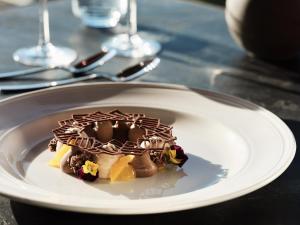 a chocolate dessert on a white plate on a table at Cora Hotel & Spa in Afitos