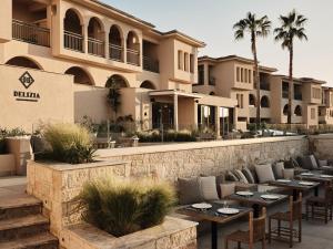 a restaurant with tables in front of a building at Cora Hotel & Spa in Afitos
