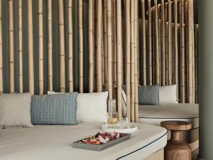 a living room with a table with a tray of food at Cora Hotel & Spa in Afitos