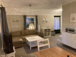 a living room with a couch and a table at Kastanienhof in Butjadingen