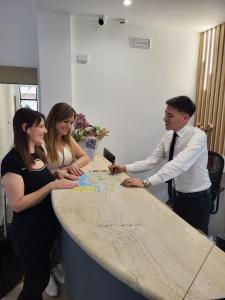 a group of people standing around a table with a map at Hotel Maiuri Pompei in Pompei