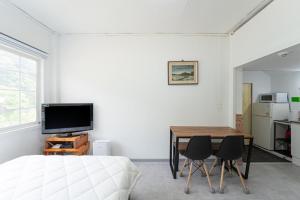 a bedroom with a bed and a table and a television at Yang yang Sanjang Love Story in Yangyang