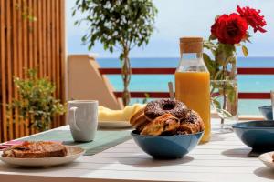 a table with plates of pastries and a bottle of orange juice at Appartamento 152 in Agrigento