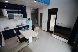 a kitchen and living room with a white table and chairs at Jeju Jayle Blanc in Jeju
