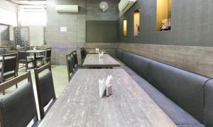 a dining room with tables and chairs in a restaurant at Treebo Bliss in Jaipur