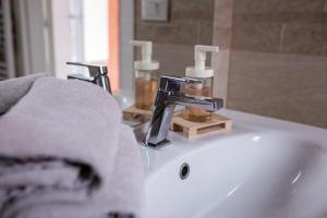 a bathroom sink with a faucet and a mirror at Bologna Travel Suite in Bologna +77 photos