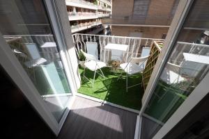 a balcony with white chairs and a table on it at Bed In Centro in Naples