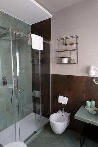 a bathroom with a shower and a toilet and a sink at Bed In Centro in Naples