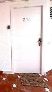 a white garage door with the number on it at Tenerife Sea View Sun Beach Apartment 214 in Playa Fañabe +53 photos