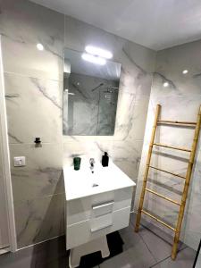 a bathroom with a white sink and a shower at Tenerife Sea View Sun Beach Apartment 214 in Playa Fañabe