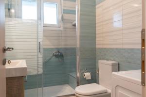 a bathroom with a shower and a toilet and a sink at Villa Brezza Di Mare - Agios Stefanos Volos in Kritharia +56 photos