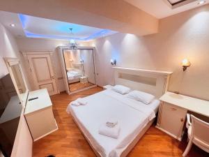 a small room with a bed and a mirror at Park Azure 0313 in Baku +18 photos
