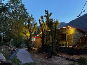 a house with a tent in front of it at Topal home stay in Gopeshwar