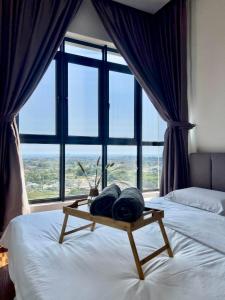 a bedroom with a bed with a large window at Hush Inn at K Avenue Kota Kinabalu in Kota Kinabalu