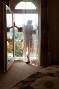 a woman standing in front of a door at Grand Hotel Kronenhof in Pontresina +154 photos