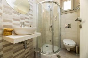 a bathroom with a sink and a shower at Perivoli Rooms in Parikia