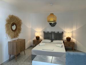 a bedroom with a bed and a mirror on the wall at Chrysa House in Kamares