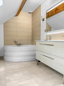 a bathroom with a bath tub and a sink at Nature et Bord d'Etang à Jars in Jars +34 photos