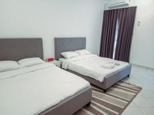 a bedroom with two beds and a window at HARF22-02 Peaceful 2BR in Abu Dhabi city in Abu Dhabi