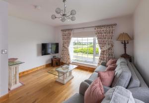 a living room with a couch and a tv at Mountain Nest at the foot of Slieve Gullion in Cloghoge