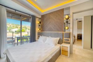 a bedroom with a bed and a balcony at Ayayorgi Homes in Çeşme +123 photos