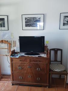 a television on top of a dresser in a room at Ty Glaz in Kerbors +8 photos