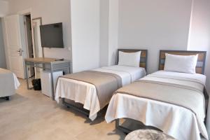 Postel nebo postele na pokoji v ubytování Anchor Alaçatı Hotel