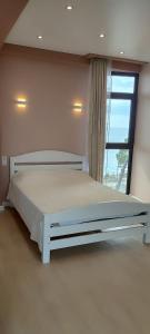 a white bed in a room with a window at Apartments - studio Katarina in K'obulet'i
