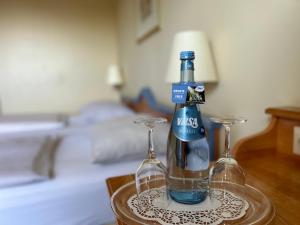 a bottle and two glasses on a table at Country Hotel Timmendorfer Strand in Timmendorfer Strand