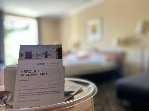a sign on top of a table in a room at Country Hotel Timmendorfer Strand in Timmendorfer Strand