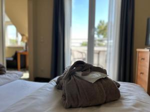 a towel is sitting on top of a bed at Country Hotel Timmendorfer Strand in Timmendorfer Strand