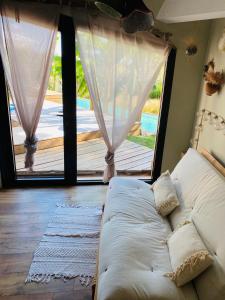a living room with a couch and a large window at Le Zingaro in Busque