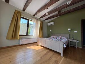 a bedroom with a bed and a large window at Villa Alessandra in Emona