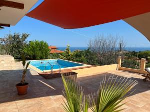 a swimming pool sitting next to a house at Villa Alessandra in Emona