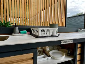 a kitchen counter with a sink and plates on it at BREZA mobile house BIG BERRY in Metlika