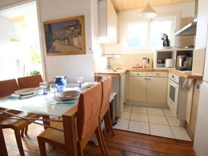 a kitchen with a table and chairs in a kitchen at Appartement T3 50m² pour 4 pers. avec Wifi et animaux admis à Luchon - FR-1-313-205 in Luchon