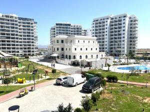 a parking lot with cars parked in front of buildings at Caesar Resort & Spa in Iskele
