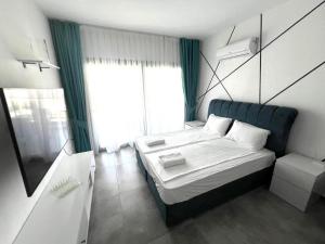 a small bedroom with a bed and a window at Caesar Resort & Spa in Iskele