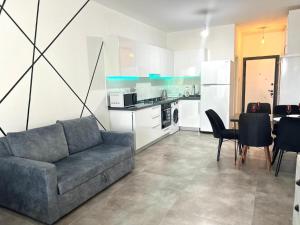 a living room with a couch and a table and a kitchen at Caesar Resort & Spa in Iskele