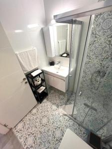 a bathroom with a shower and a sink and a mirror at Caesar Resort & Spa in Iskele +15 photos