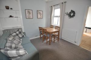 a living room with a couch and a table at Exeter Quay & City Centre St Leonards in Exeter