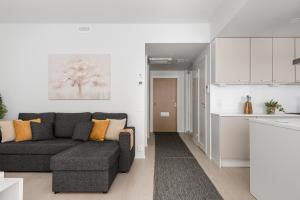 a living room with a couch and a kitchen at Borg Katarina - Riverside View in Pori +11 photos