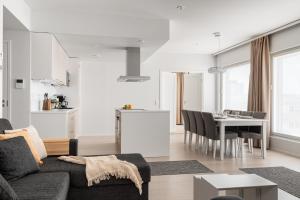 a living room with a couch and a table at Borg Katarina - Riverside View in Pori